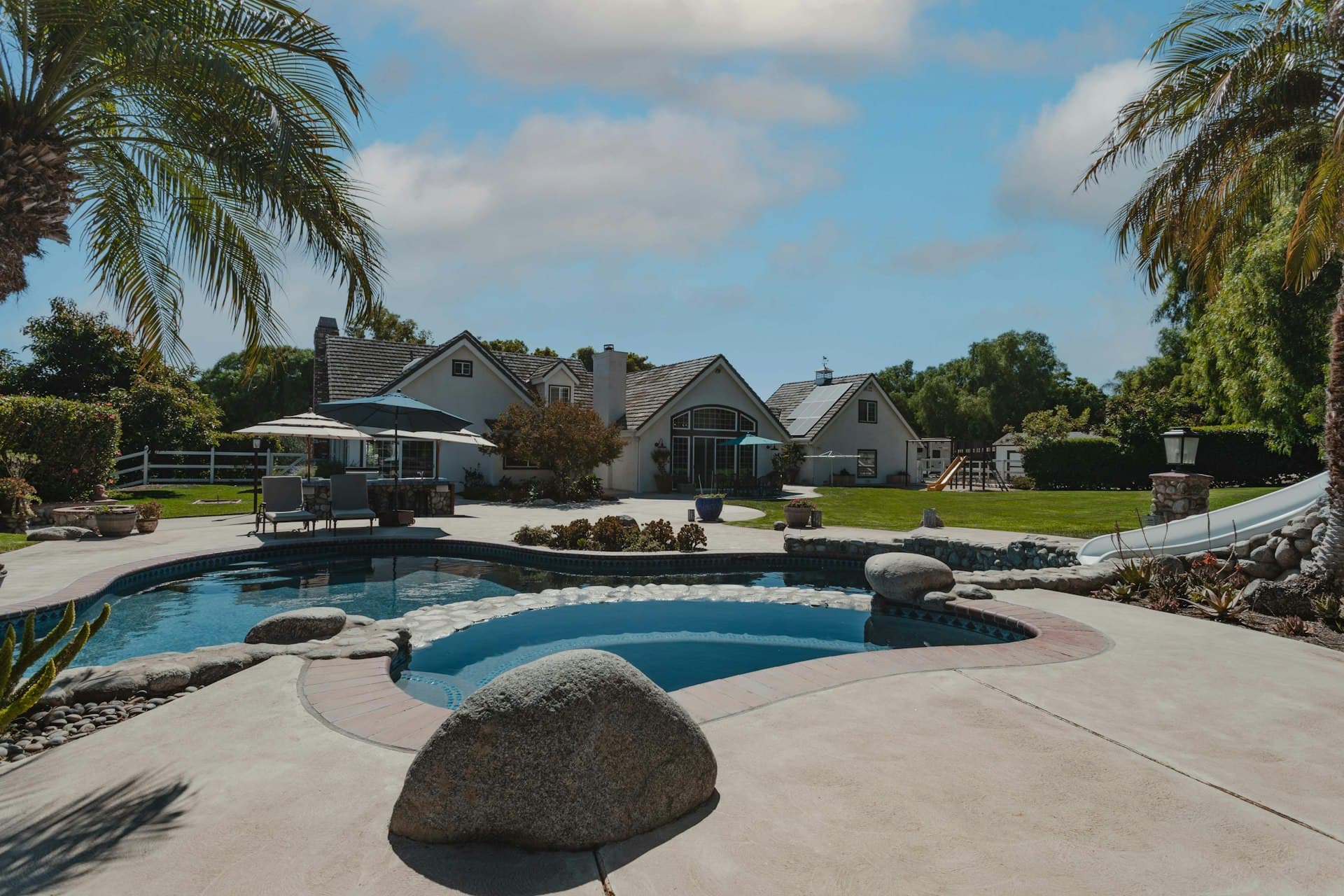 Luxury resort-style pool surrounded by palm trees